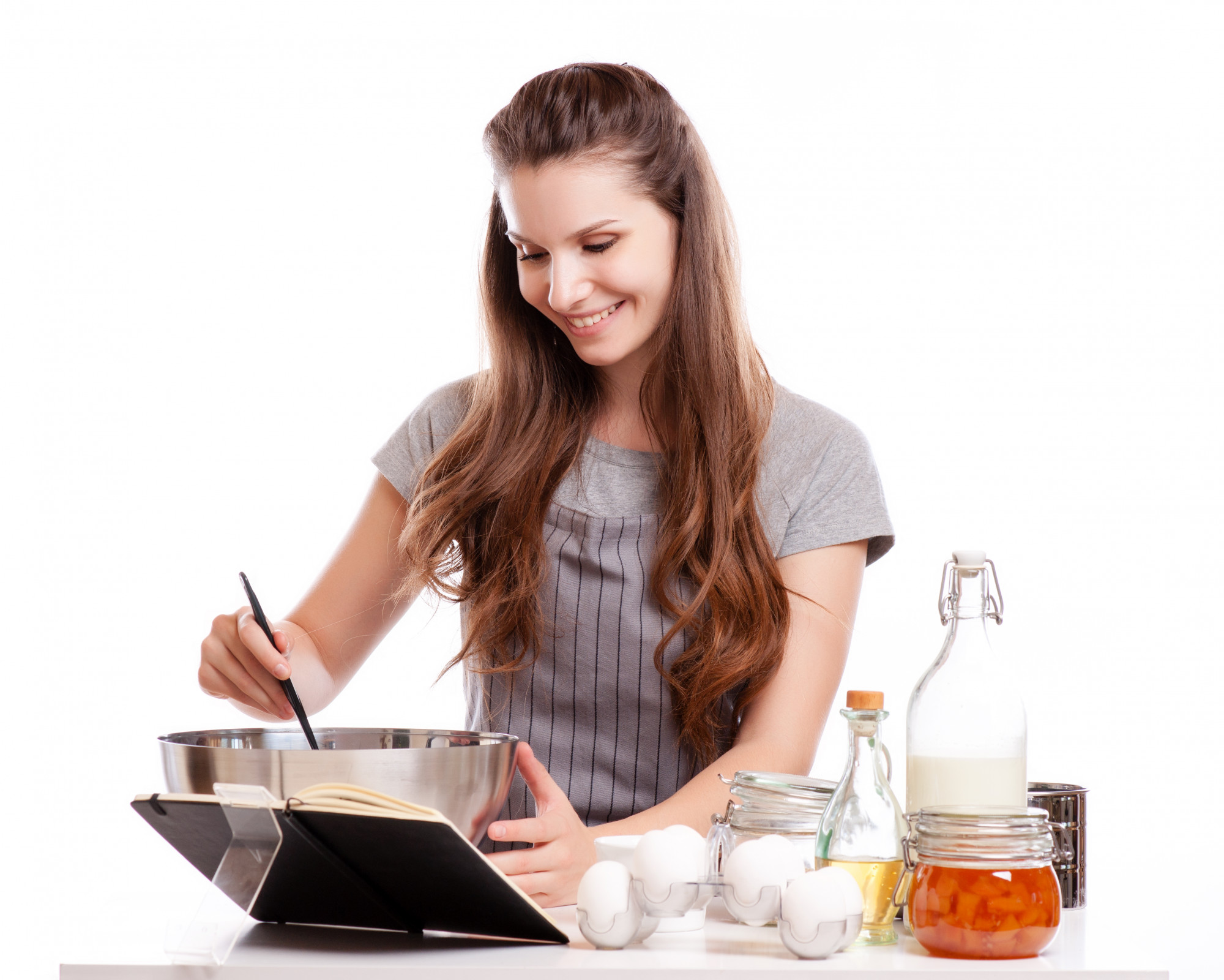 Student cooking in a home kitchen during a live session